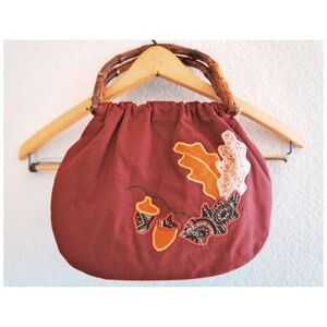1970s handbag with embroidered design and bamboo handles